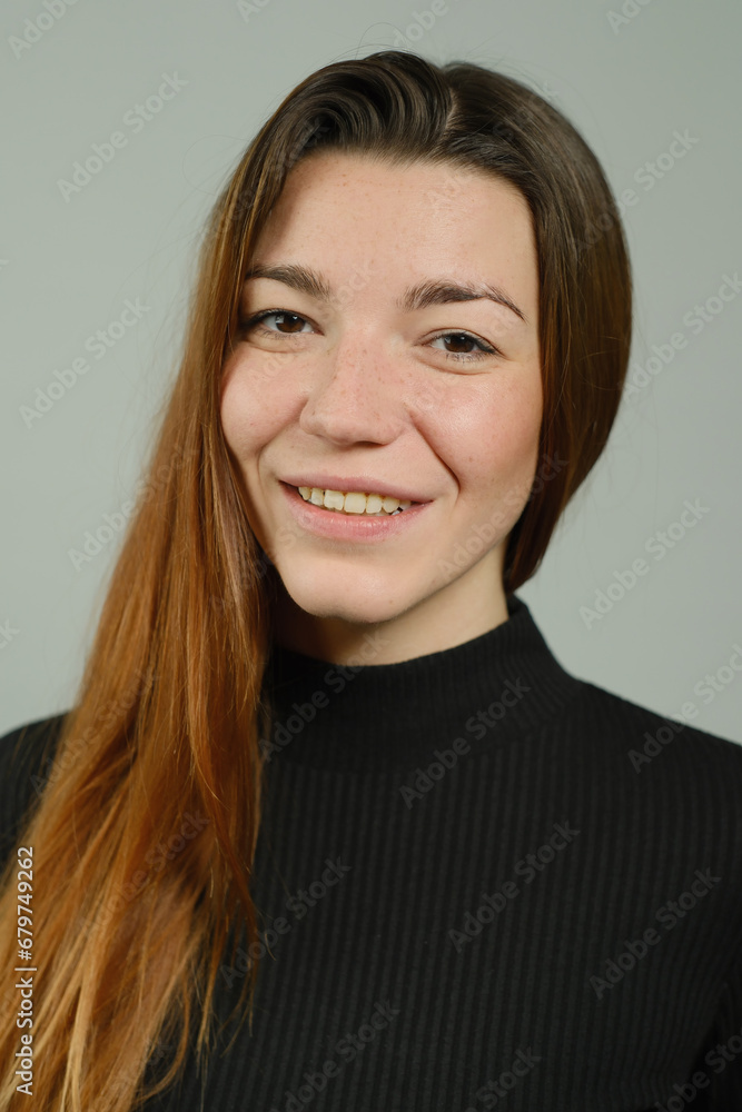 Fototapeta premium Portrait of a young pretty girl with long red hair