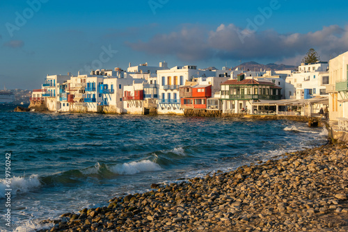 Panoramic view of Little Venice Mykonos (Chora), Cyclades Islands, Aegean Sea, Greece. Wterfront with rows of fishing houses line the waterfront with their balconies hanging over the sea. © Luis