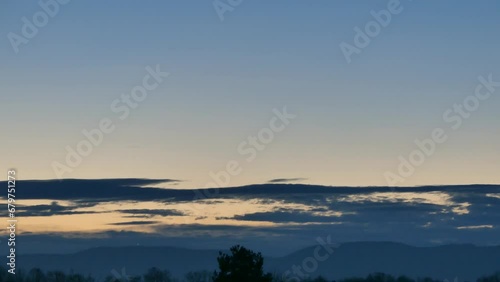 Wallpaper Mural Morning blue sky with slowly moving dark clouds before sunrise over horizon of Silesian Beskid mountains in Poland with glowing Christian cross - real time. Topics: weather, atmosphere, dawn, weather Torontodigital.ca