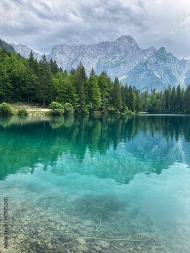 Amazing reflection of the mountain and the trees in the water of the Lago Inferiore di Fusine in the Julian Alps in the north of Italy close to Tarvisio
