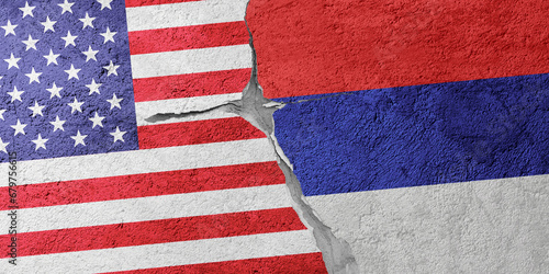 USA and Serbia flags on a stone wall with a crack, illustration of the concept of a global crisis in political and economic relations
