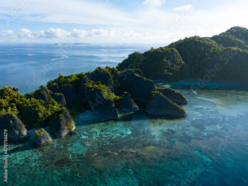 The incredibly scenic islands of Penemu are surrounded by beautiful coral reefs. These islands, found in northern Raja Ampat, support an amazing array of biodiversity. photo