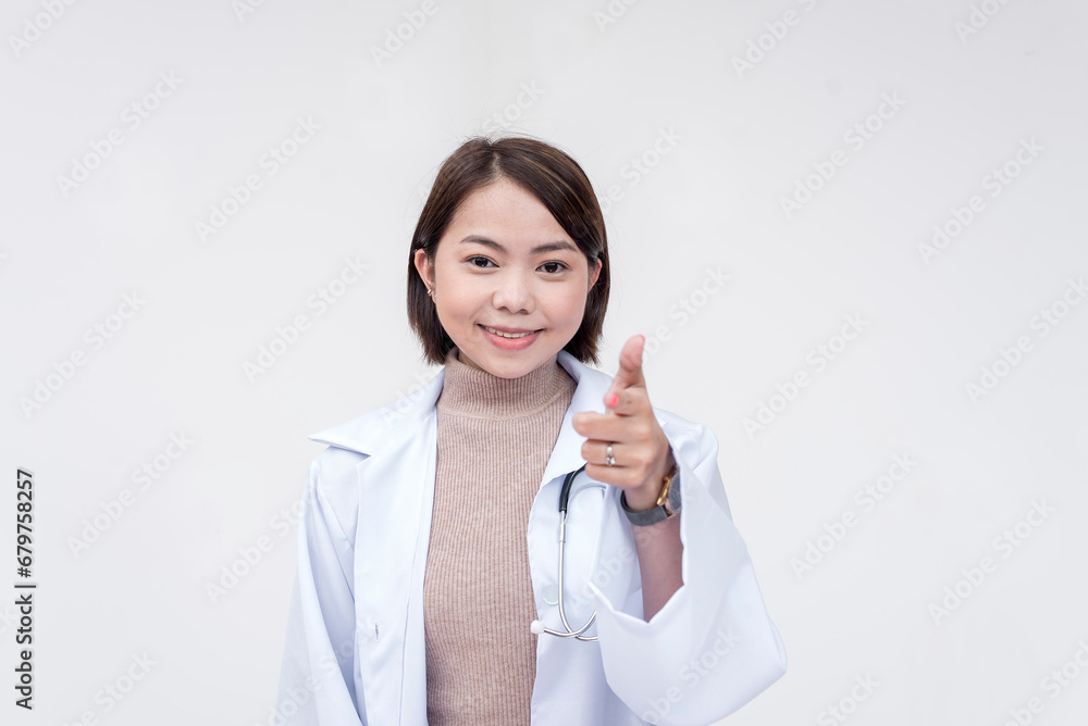 Portrait of a young and skilled doctor, medical student, intern, posing while pointing at the camera. Isolated on a white background. Portrait of a young and skilled doctor, medical student, intern, posing while pointing at the camera. Isolated on a white background.