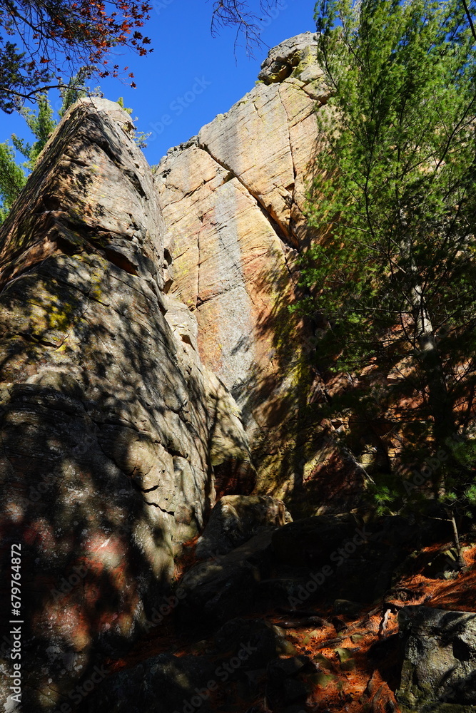 Tall rock stone formations sit in a forest for rock climbing.