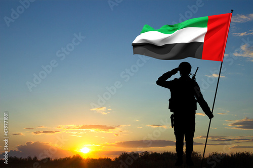 Billede på lærred Silhouette of saluting soldier with the flag of UAE against the sunset