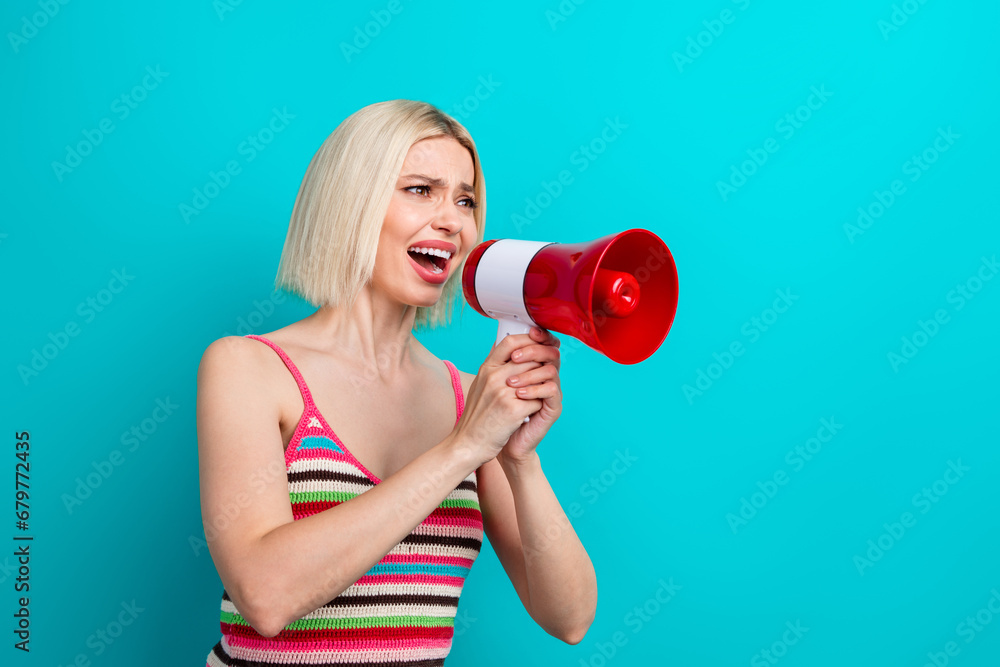Photo portrait of pretty young girl confused scream hold loudspeaker dressed stylish striped outfit isolated on aquamarine color background Photo portrait of pretty young girl confused scream hold loudspeaker dressed stylish striped outfit isolated on aquamarine color background