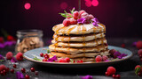 A stack of delicious pancakes with syrup, powdered sugar and berries