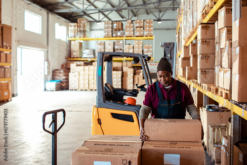 Male warehouse workers loading or unloading boxes photo