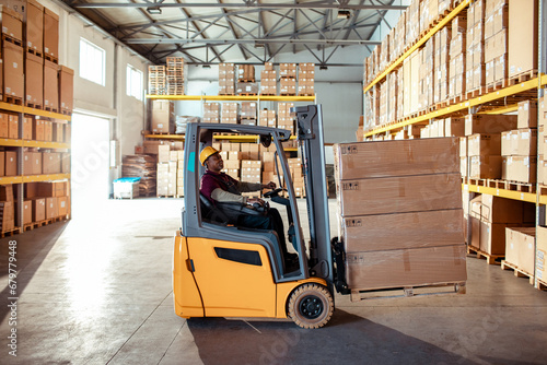 Male Forklift Operator at Work in Warehouse photo
