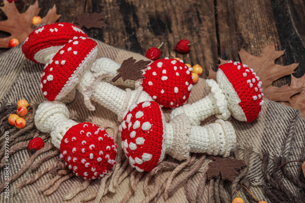 Autumn cozy mood composition. Crocheted amanita mushroom, handmade, fall hobby concept