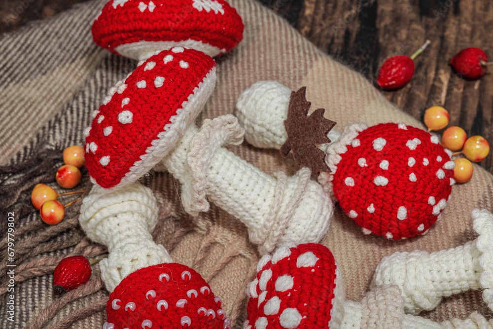 Autumn cozy mood composition. Crocheted amanita mushroom, handmade, fall hobby concept