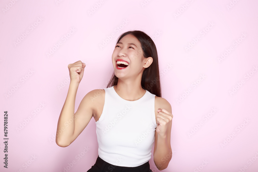 Portrait of a beautiful young woman in a light pink background, The Asian woman was acting very cheerful, Beautiful girl smiling happily. Portrait of a beautiful young woman in a light pink background, The Asian woman was acting very cheerful, Beautiful girl smiling happily.