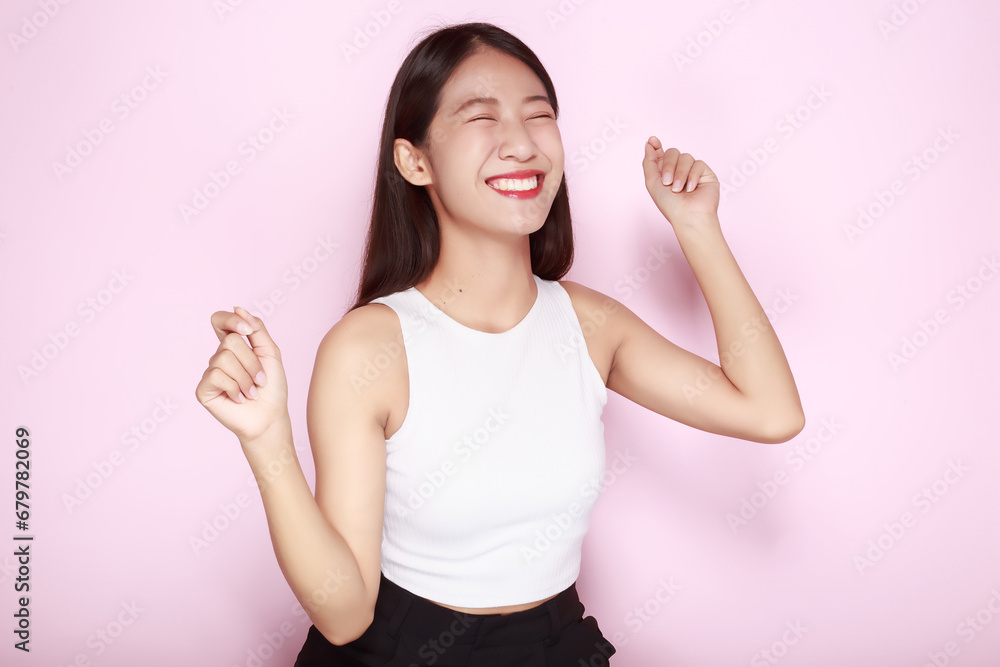 Portrait of a beautiful young woman in a light pink background, The Asian woman was acting very cheerful, Beautiful girl smiling happily. Portrait of a beautiful young woman in a light pink background, The Asian woman was acting very cheerful, Beautiful girl smiling happily.