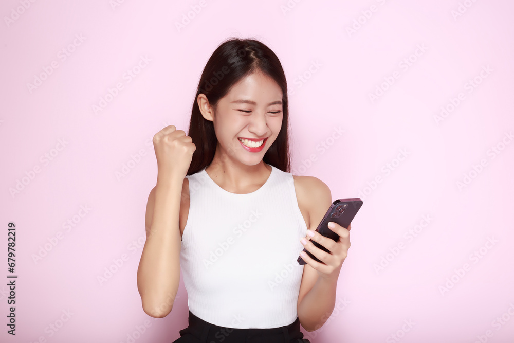 Portrait of a beautiful young woman in a light pink background, The Asian woman was acting very cheerful, Beautiful girl smiling happily. Portrait of a beautiful young woman in a light pink background, The Asian woman was acting very cheerful, Beautiful girl smiling happily.