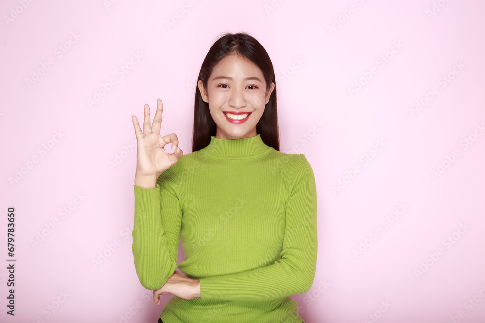 Asian woman making OK gesture with her hands, Portrait of a friendly young woman smiling happily, Portrait of a beautiful young woman in a light pink background, Asian woman making OK gesture with her hands, Portrait of a friendly young woman smiling happily, Portrait of a beautiful young woman in a light pink background,