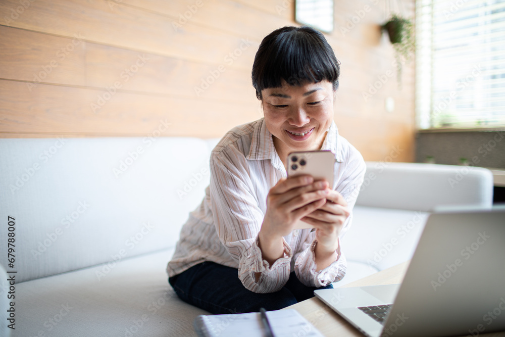 Cheerful Asian Woman Enjoying a Video Call on Mobile Phone Cheerful Asian Woman Enjoying a Video Call on Mobile Phone