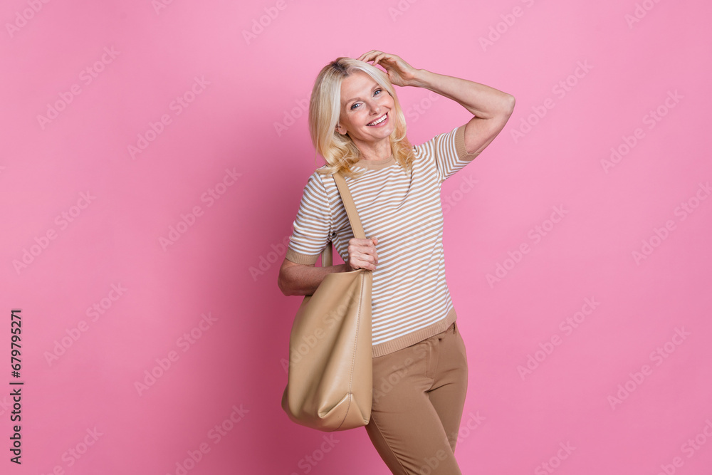 Photo of positive glad lady dressed stylish clothes hold bag enjoy shopping isolated on pink color background Photo of positive glad lady dressed stylish clothes hold bag enjoy shopping isolated on pink color background