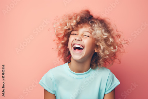 Young laughing woman against pastel color background