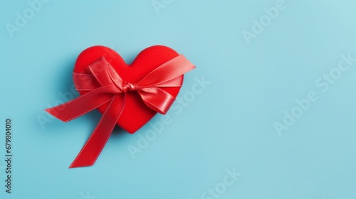 Top view photo of valentine`s day decorations red ribbon heart on isolated pastel blue background with copyspace