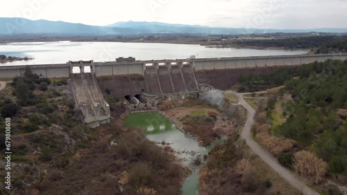 Drone video approaching the gravity dam with irrigation and water containment functions of Bellús, in the province of Valencia, Spain, above the Albaida river photo