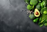 Fresh green vegetables on a black background. Top view with copy space.
