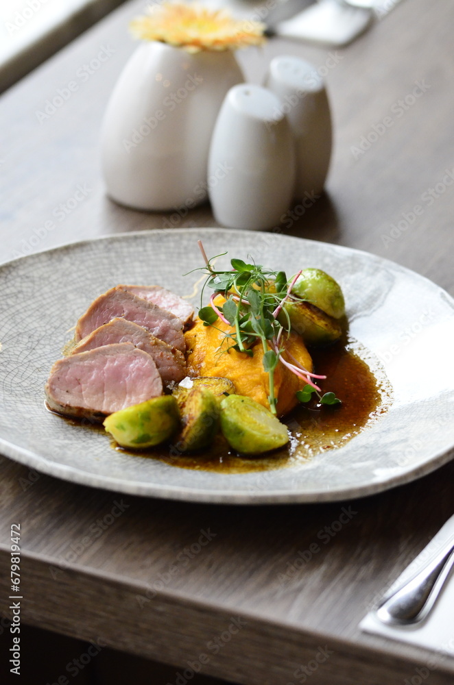 roasted pork loin with brussels sprouts and sauce, serving food roasted pork loin with brussels sprouts and sauce, serving food