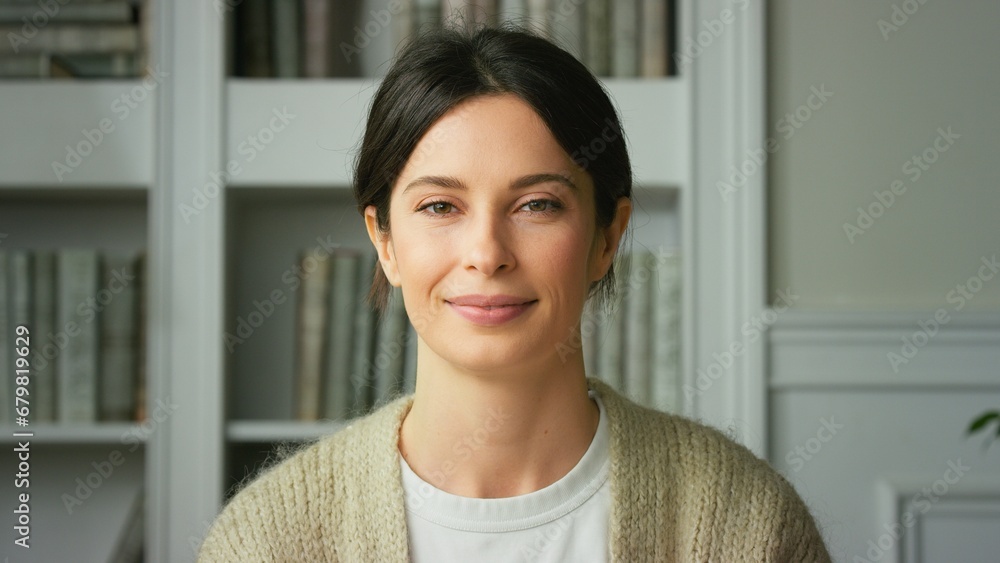 Portrait of a beautiful smiling confident young woman posing alone at home in office. European woman standing indoor smiling looking at camera. Happy casual lady with pretty face. Close up Portrait of a beautiful smiling confident young woman posing alone at home in office. European woman standing indoor smiling looking at camera. Happy casual lady with pretty face. Close up