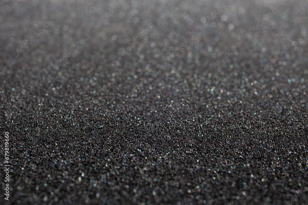 Black foam rubber. Closeup full-frame macro background with selective focus and shallow depth of field.