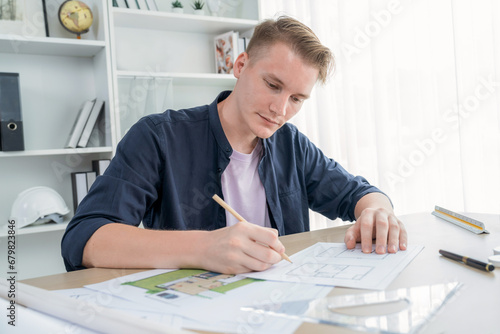 Portrait of architect designer sit at desk in office, brainstorm idea for architectural design project, working on blueprint drafting. Passionate and innovative creativity in architecture. Iteration