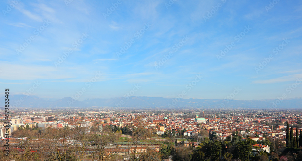 city of Vicenza with monuments and mountains in the background and wide blue sky at the top ideal for personalizing it with a TEXT