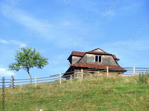 Abandoned old wooden house on top of a hill