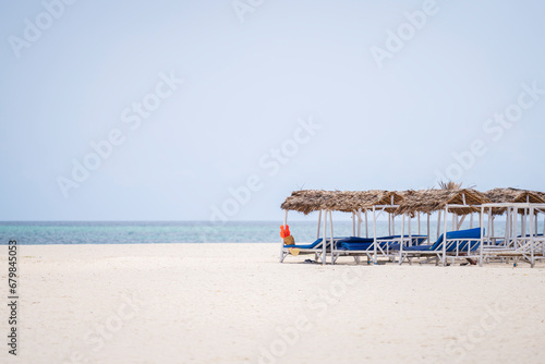White sandy beach turquoise ocean and deck chairs at the beach at sunny day  luxury beach house.Zanzibar Tanzania.