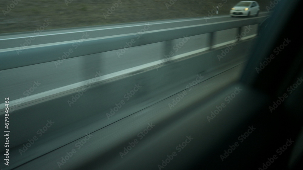 Backseat passenger POV on highway road in motion speed Backseat passenger POV on highway road in motion speed