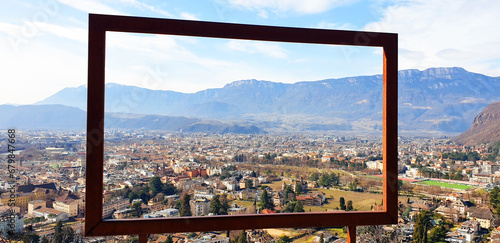 View of the city of Bolzano through an iron frame. Panorama.