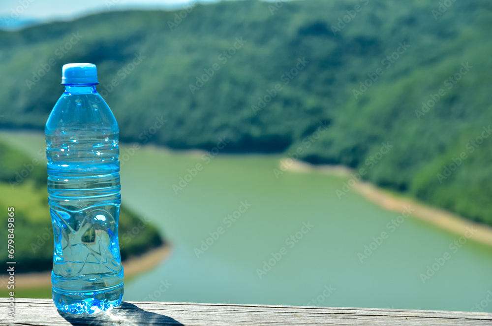 Water bottle in the nature, mountain, lake, healthy air Water bottle in the nature, mountain, lake, healthy air