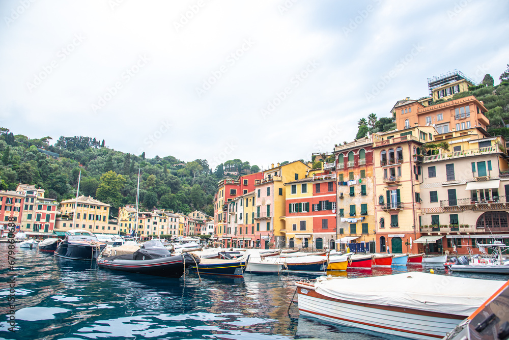 Panoramic view to the pier and colorful  apartments and Italian architecture of the see and the boat Portofino, Italy