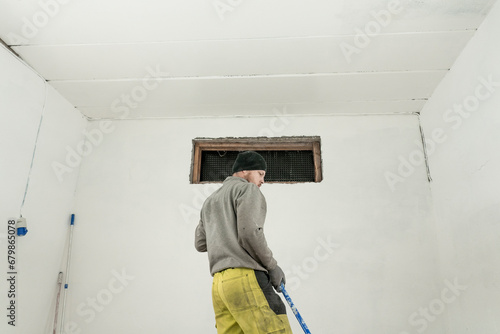 Skilled Craftsman Painting a Room in Fresh Overalls with Precision and Care. © oleksandr
