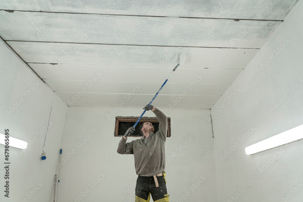 Skilled Artisan Painting Garage in Pristine White - Expert Home Improvement. Skilled Artisan Painting Garage in Pristine White - Expert Home Improvement.