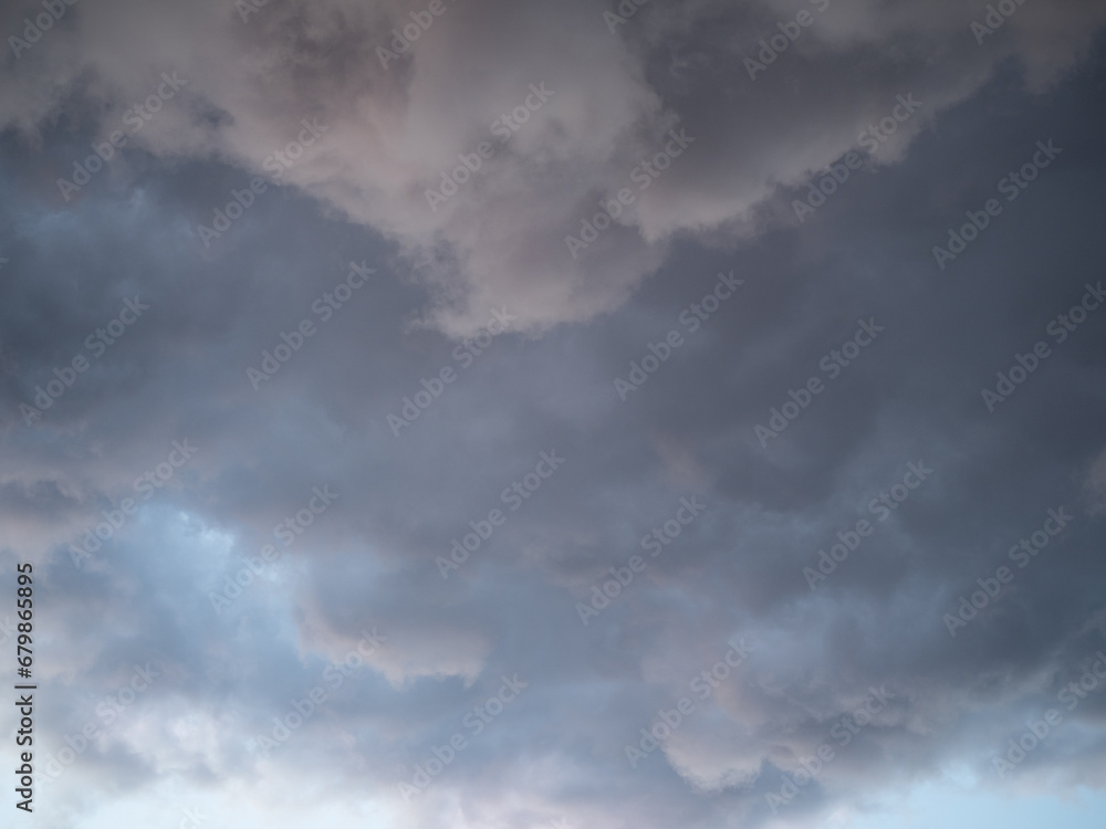 Blue sky after rain,. Beautiful Cumulus clouds flying across the sky, sunset rays, pink and orange shades in the clouds, deep blue sky Blue sky after rain,. Beautiful Cumulus clouds flying across the sky, sunset rays, pink and orange shades in the clouds, deep blue sky