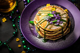Mardi Gras pancakes on purple plate and decoration