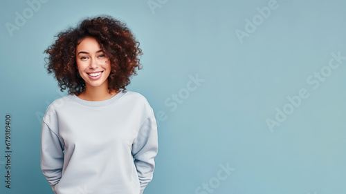Afro american woman wearing white sweatshirt isolated on pastel