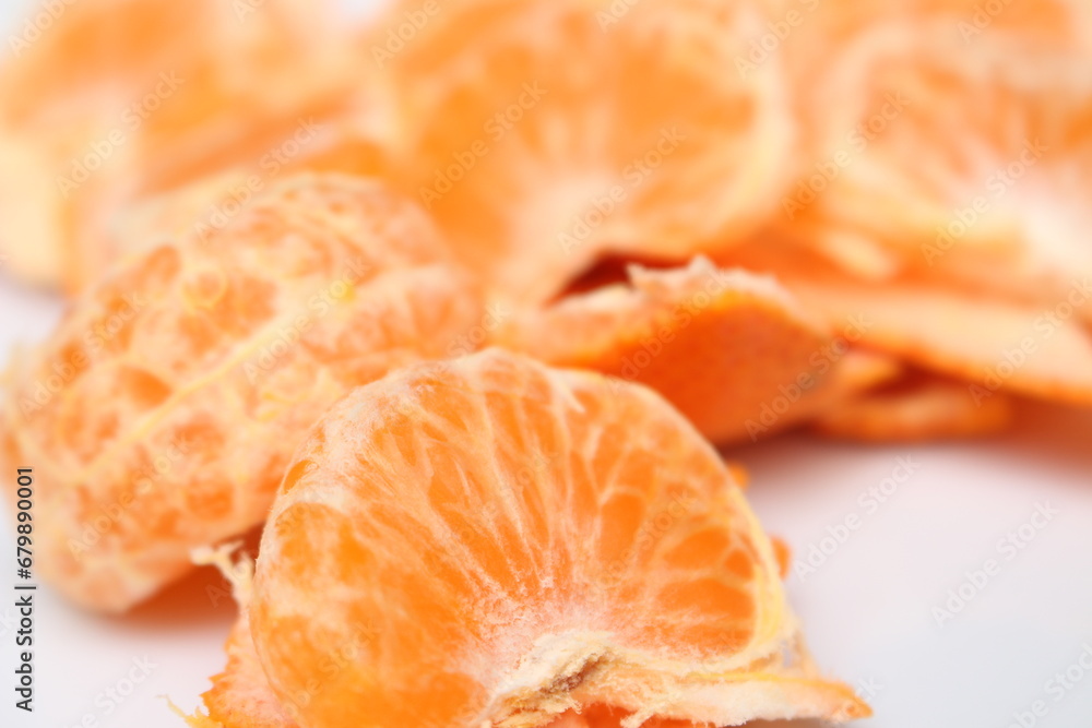 peeled tangerine slices. tangerine segments with selective focus. ready-to-eat tangerines. orange natural food.