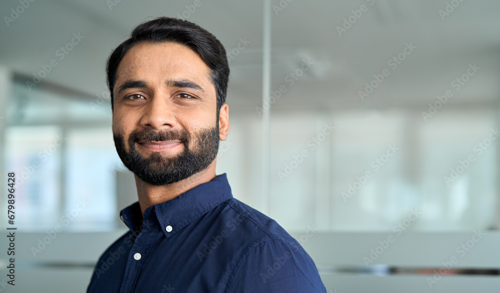 Confident Indian business man lawyer, professional businessman manager in office, corporate executive, handsome leader, male employee from India looking at camera, headshot close up face portrait.