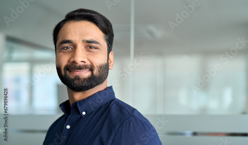 Confident Indian business man lawyer, professional businessman manager in office, corporate executive, handsome leader, male employee from India looking at camera, headshot close up face portrait.