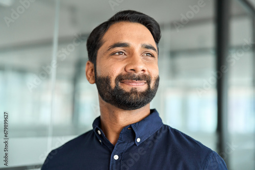 Confident smiling Indian business man, bearded professional businessman manager in office, corporate executive leader, male entrepreneur from India looking away, headshot close up face portrait.