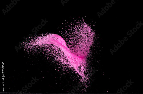 Pink Sand flying explosion, particle dot grain wave explode. Abstract cloud fly. Choky pink colored sand splash throwing in Air. Black background Isolated photo