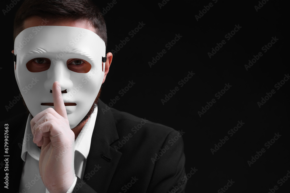 Man in mask and gloves showing hush gesture against black background. Space for text Man in mask and gloves showing hush gesture against black background. Space for text