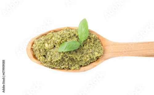 Wooden spoon with delicious pesto sauce and basil isolated on white  top view
