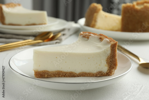 Piece of tasty vegan tofu cheesecake on white table, closeup photo