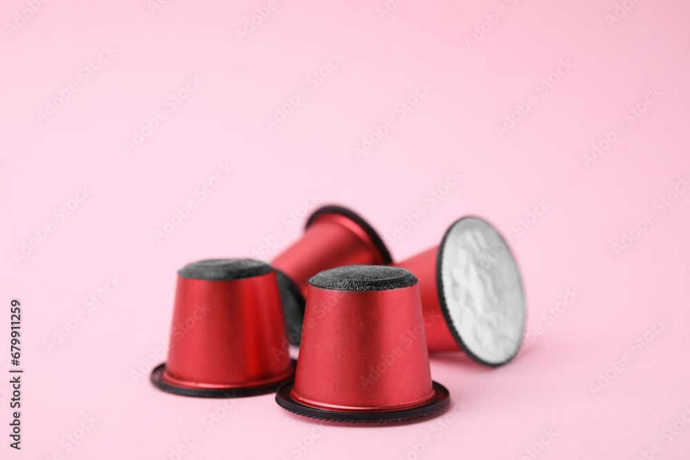 Many plastic coffee capsules on pink background, closeup Many plastic coffee capsules on pink background, closeup